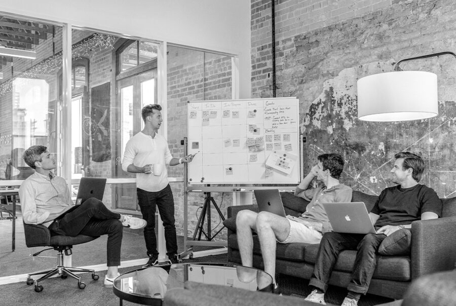 Group in meeting room, collaborating in a Christian business peer group.