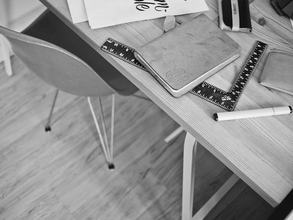 Desk with laptop and empty chair, ready for executive coaching sessions.